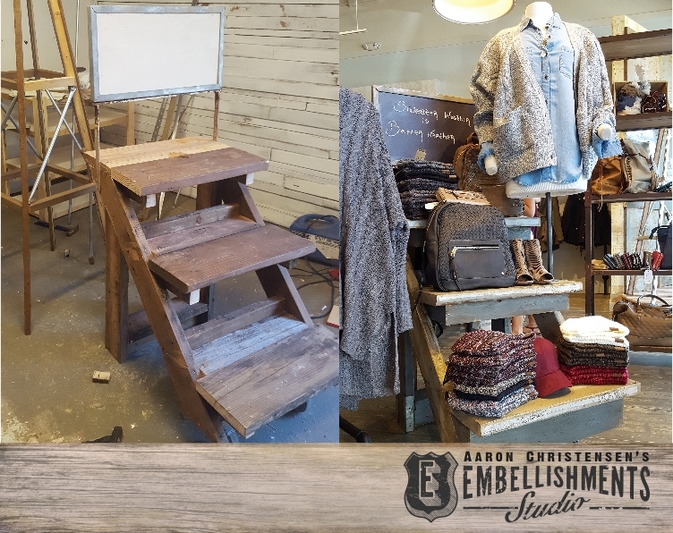 Cut up metal channel, rusty metal railing, old wood, wheelbarrel handles and wheels are reworked and transformed into a mechandising cart, like those use by vendors.  The piece by Aaron Christensen was designed to serve as a seasonal store fixture for an apparel boutique.  The painted chalkboard sign reads 